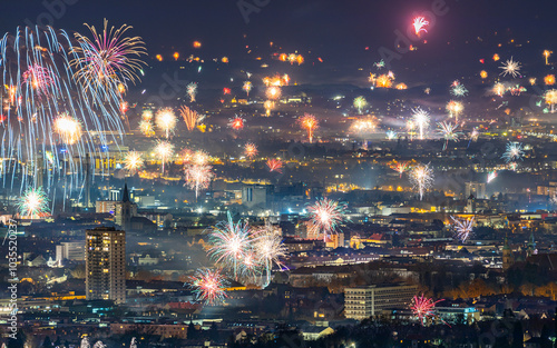 View of colorful fireworks over a vibrant city skyline during new year's eve celebration, Graz, Austria. photo