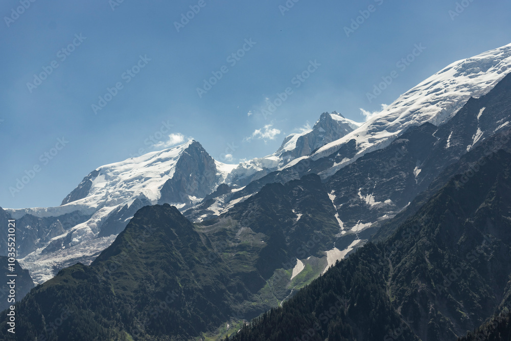 View of majestic Mont Blanc surrounded by snowy peaks and clouds, Chamonix-Mont-Blanc, France. View of majestic Mont Blanc surrounded by snowy peaks and clouds, Chamonix-Mont-Blanc, France.