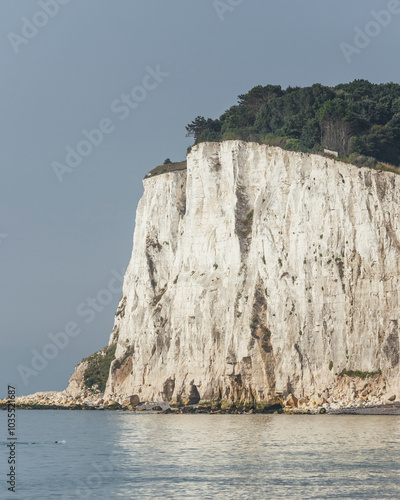 View of the iconic white cliffs overlooking the serene sea and sky, St Margaret's at Cliffe, United Kingdom. photo