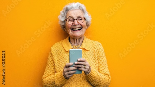 A charismatic elderly woman laughing while holding a smartphone, set against a vibrant orange background. Her joyful expression reflects the essence of modern senior lifestyle
