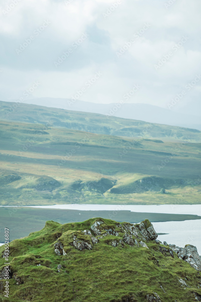 View of Loch Leathan and the Old Man of Storr surrounded by majestic mountains and lush hills, Portree, Scotland. View of Loch Leathan and the Old Man of Storr surrounded by majestic mountains and lush hills, Portree, Scotland.