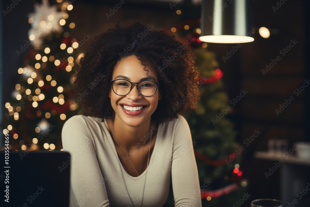 Smiling portrait of a middle aged woman in startup office decorated for Christmas Smiling portrait of a middle aged woman in startup office decorated for Christmas