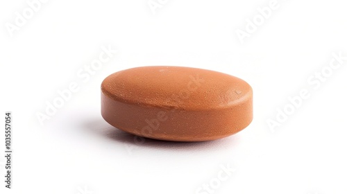 Brown herbal pill tablet on white background - a natural remedy in a simple yet striking presentation