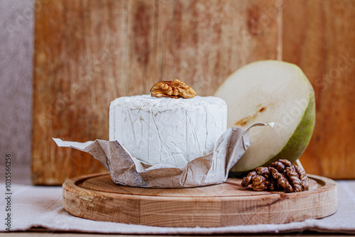 Blue cheese with walnuts on cutting board