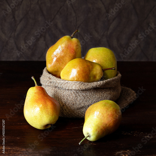 Fresh ripe pears on wooden table against blurred background