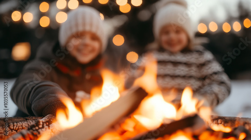 Two children enjoy a cozy winter evening by the fire, surrounded by soft glowing lights and a snowy backdrop, creating a warm holiday atmosphere.