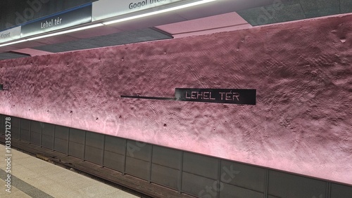 Empty subway platform with overhead lighting and tiled walls photo