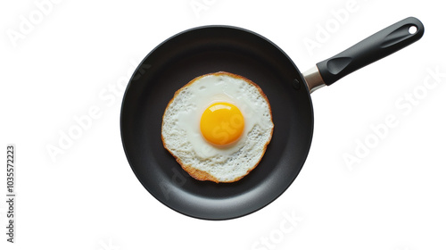 Fried egg in a black non-stick frying pan isolated on transparent background
