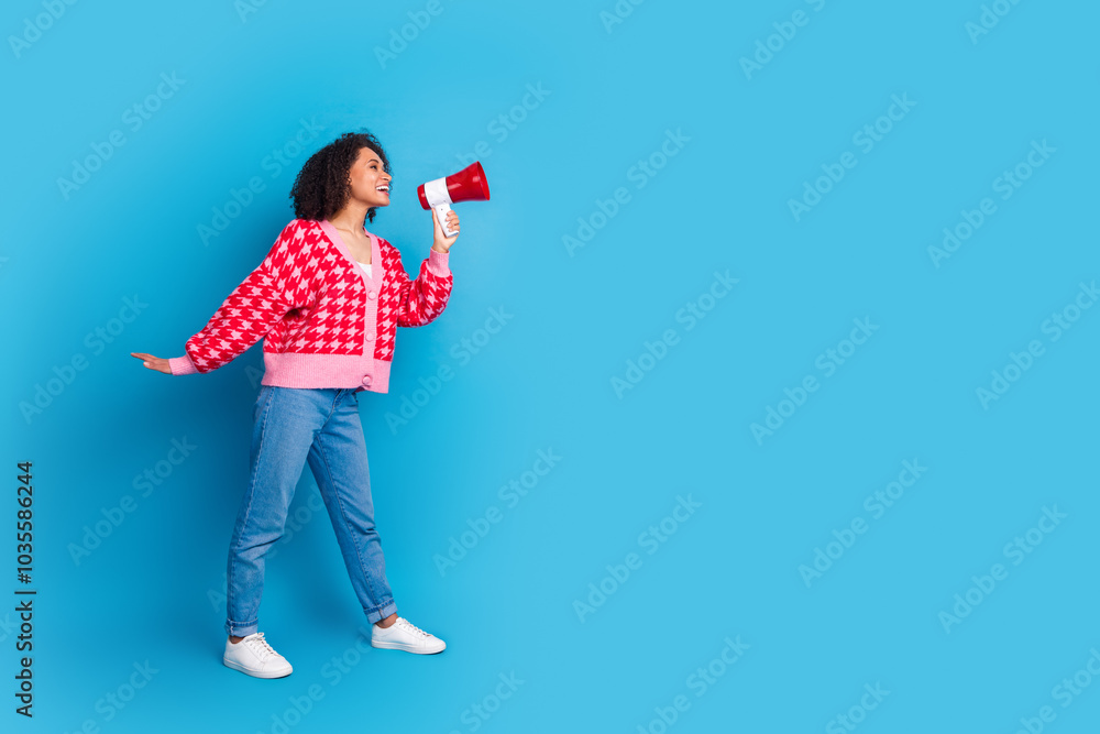 Portrait photo of american beautiful girl with curly hair wearing red stylish cardigan proclaim information isolated on blue color background Portrait photo of american beautiful girl with curly hair wearing red stylish cardigan proclaim information isolated on blue color background