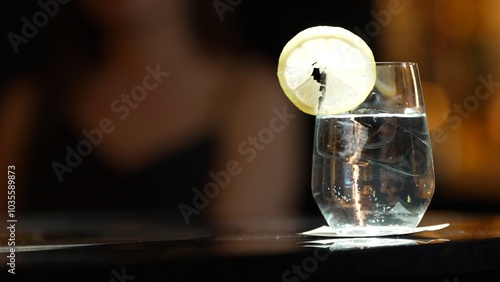 Closeup of gin fizz cocktail garnished slice lemonade serving to customer background on luxury counter bar at nightclub. Special sour drink showcasing elegance nightlife mixology inviting. Vinosity. photo