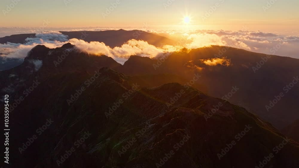 Aerial view of flying at Pico Ruivo of mountains with clouds on sunset. Madeira island, Portugal. Pull away out retreat dolly shot Aerial view of flying at Pico Ruivo of mountains with clouds on sunset. Madeira island, Portugal. Pull away out retreat dolly shot