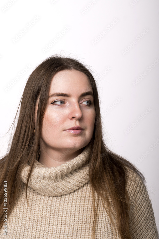 A 25-year-old woman in a light gray sweater looking off to the side, against a white background. Ideal for themes of fashion, casual style, or a neutral lifestyle concept A 25-year-old woman in a light gray sweater looking off to the side, against a white background. Ideal for themes of fashion, casual style, or a neutral lifestyle concept