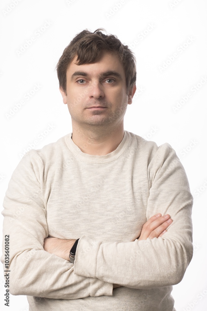 A man in a beige sweater with folded arms standing against a clean white background. Ideal for professional and personal projects that emphasize simplicity and confidence. A man in a beige sweater with folded arms standing against a clean white background. Ideal for professional and personal projects that emphasize simplicity and confidence.