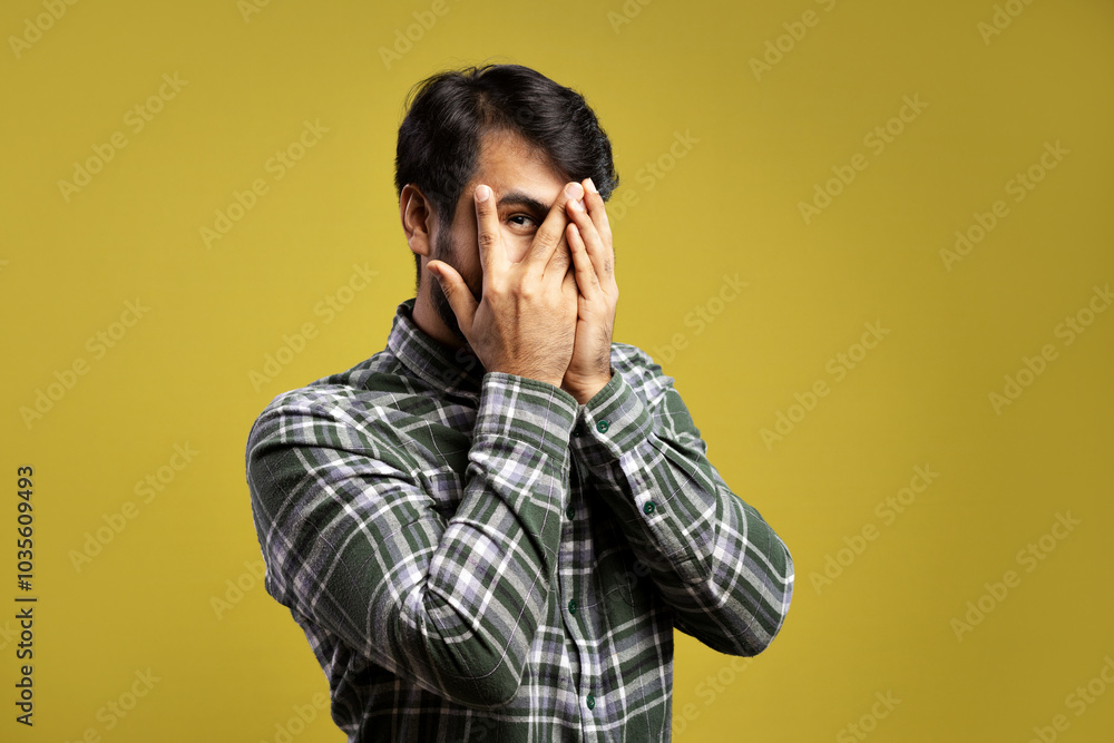 man looking through the fingers of his hand man looking through the fingers of his hand