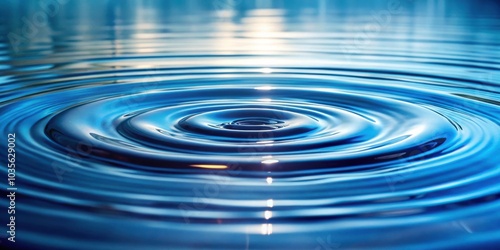 The serenity of a single drop of water rippling outwards, creating a symphony of concentric circles on the tranquil surface of a blue liquid.