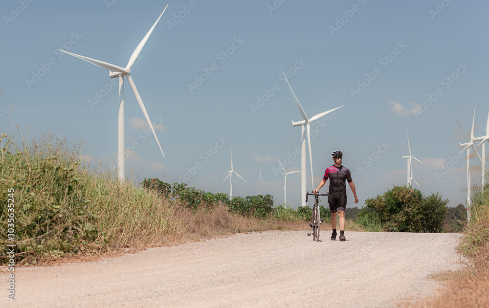 Obraz premium Cyclists are riding their bikes for training and touring the wind farms