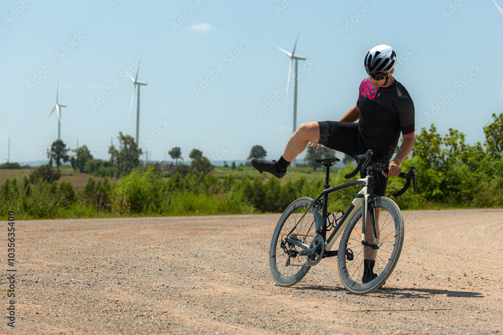 Obraz premium Cyclists are riding their bikes for training and touring the wind farms