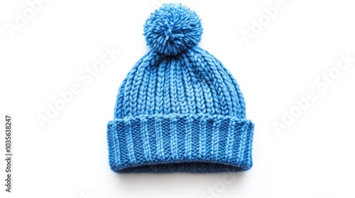 A cozy blue knitted beanie with a pom-pom on top, perfect for cold weather.