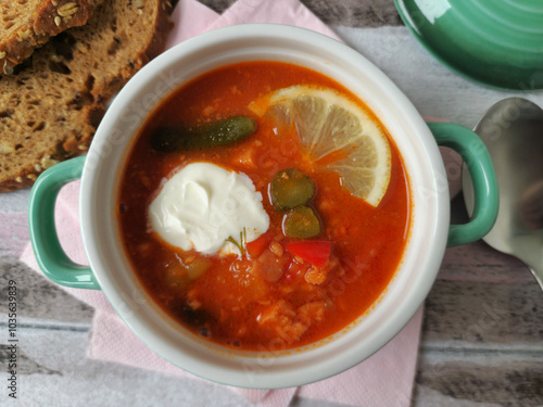 Foto Traditional East German Soljanka Soup with Pickles, Leftover Sausage  and Sour C