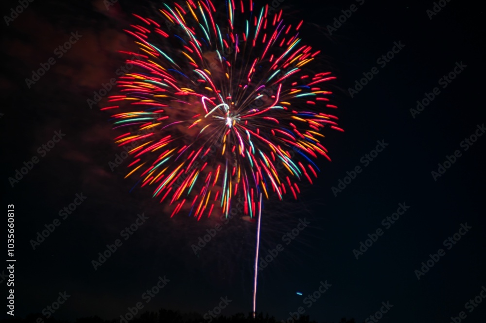 Vibrant firework display lighting up the night sky with colorful bursts. Vibrant firework display lighting up the night sky with colorful bursts.