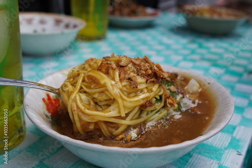 A bowl of Mie Ongklok, a popular Indonesian noodle dish. photo