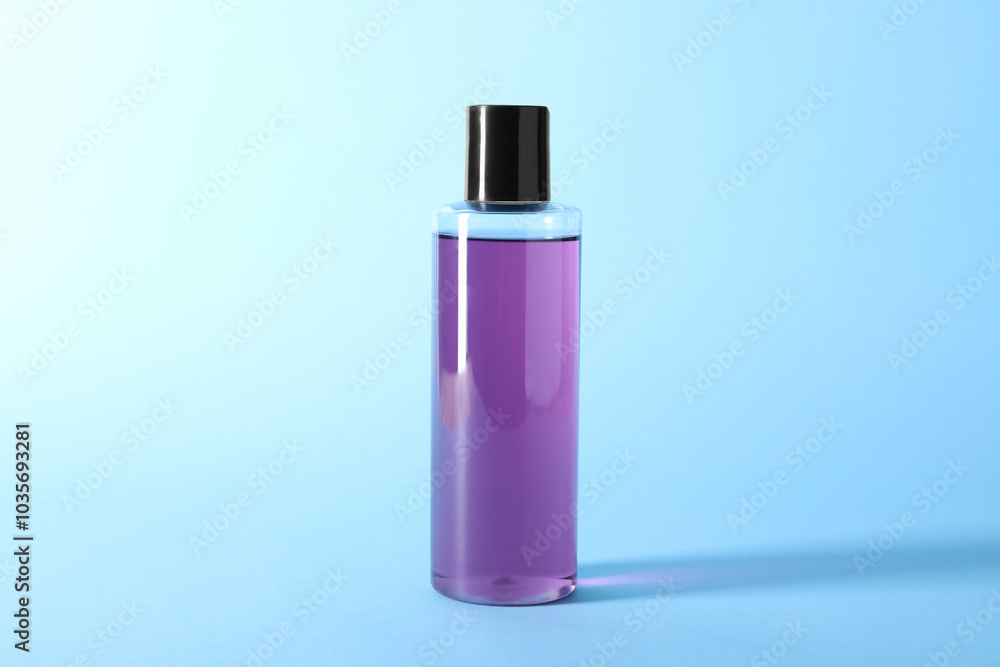 Shampoo in bottle on light blue background. Personal care product Shampoo in bottle on light blue background. Personal care product