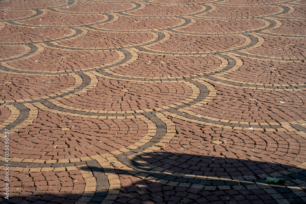 Pattern of cobblestones forms an intricate street design. Pattern of cobblestones forms an intricate street design.