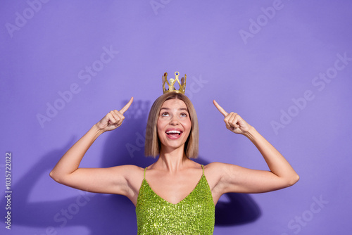 Photo of bob blonde hair young happy woman wear crown index fingers up head promoting sale isolated on violet color background photo