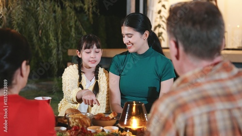 Family gather celebrate holiday. Parents, grandparents and girl together to talk and have dinner party food. Outdoor activity for spending time with multigeneration cross generation gap. Divergence. photo