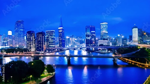 Wallpaper Mural A nighttime cityscape with skyscrapers lit up and reflections on a river. The image captures the beauty of a vibrant urban skyline at night. Torontodigital.ca