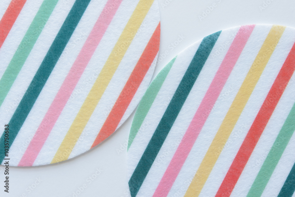 large round felt fabric shapes with colorful and white stripes on blank paper large round felt fabric shapes with colorful and white stripes on blank paper