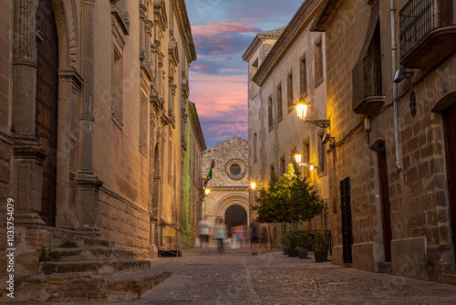 Street of the historic center of Baeza with blurred people walking in Baeza, Jaén, Andalusia, Spain at dusk, UNESCO heritage