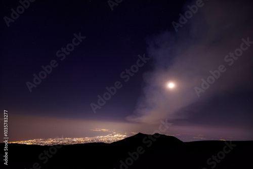 Golfo Catania visto di notte dall'alto sull' Etna sotto il cielo limpido di stelle photo