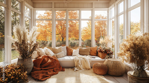Sunroom in Fall, a sunroom with cozy seating, layered blankets, and large potted plants., fall season with orange and brown accents and dried flowers for a nature-inspired atmosphere.