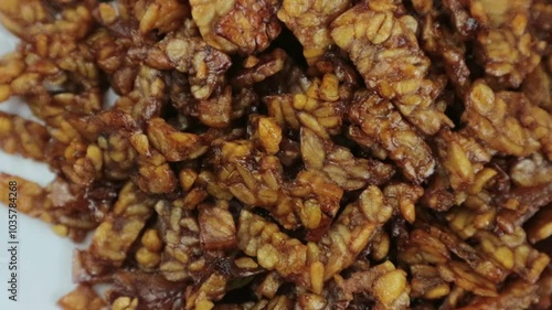 Kering Tempe, or Orek Tempe, or spicy sweet fried tempeh is an Indonesian traditional food. Rotary display photo