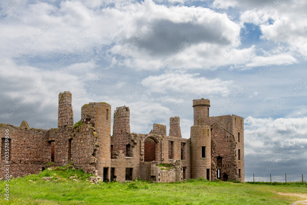 Ruins of (New) Slains Castle in Aberdeenshire, Scotland on cliffs on North Sea shore near Peterhead, UK against a dark clouded sky Ruins of (New) Slains Castle in Aberdeenshire, Scotland on cliffs on North Sea shore near Peterhead, UK against a dark clouded sky