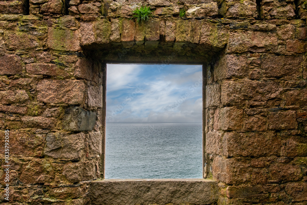 Window in stone wall with see through view on North Sea waters from ruins of (New) Slains Castle in Aberdeenshire, Scotland on cliffs near Peterhead, UK Window in stone wall with see through view on North Sea waters from ruins of (New) Slains Castle in Aberdeenshire, Scotland on cliffs near Peterhead, UK