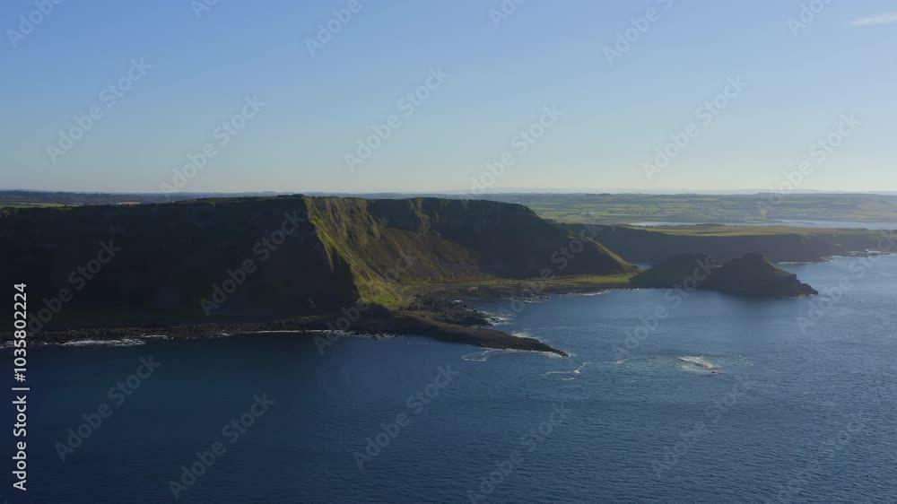 Aerial panoramic view of the Giant's Causeway on a summer evening, captured from the sea