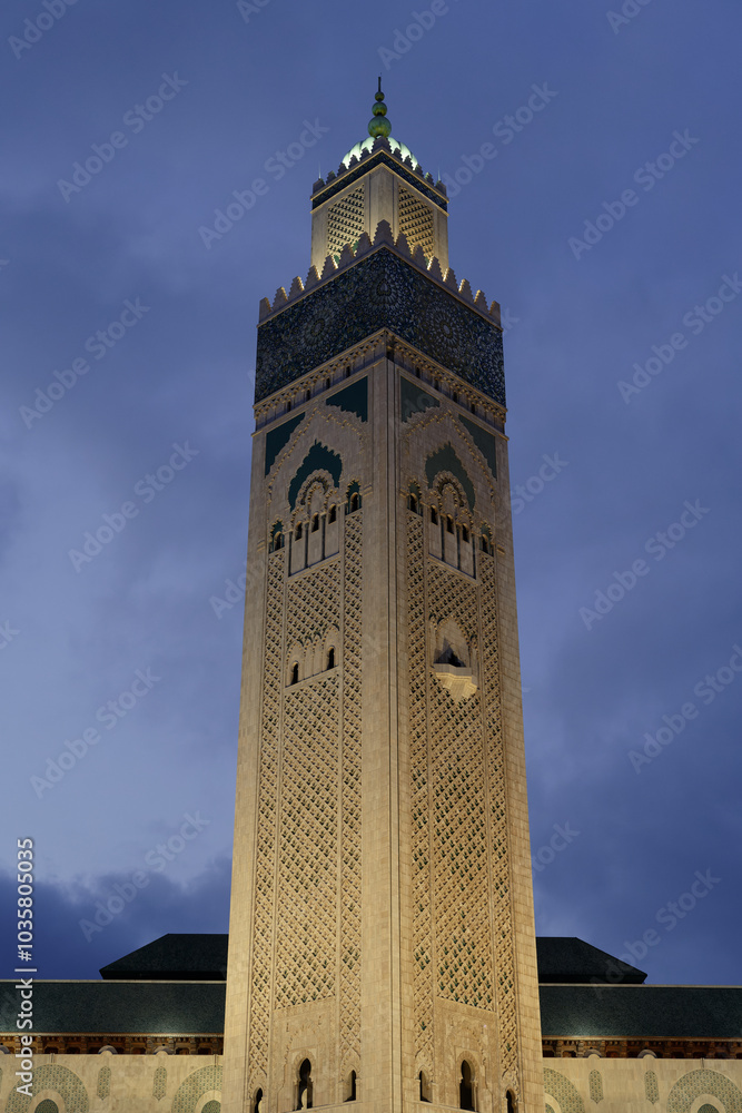Fototapeta premium Casablanca, Morocco : The minaret, or tower, of the Hassan II mosque, also called the Great Mosque. Night picture, black sky.