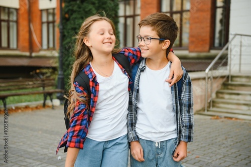 School friends, a boy and a girl spend time together near the school. Back to school