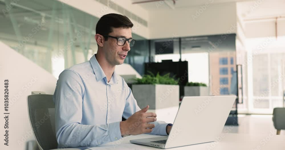 Man engaged in videocall, sit at desk, provide help, consulting, interacting with business partner on laptop. Business video call event, virtual meeting, professional interaction with corporate client Man engaged in videocall, sit at desk, provide help, consulting, interacting with business partner on laptop. Business video call event, virtual meeting, professional interaction with corporate client