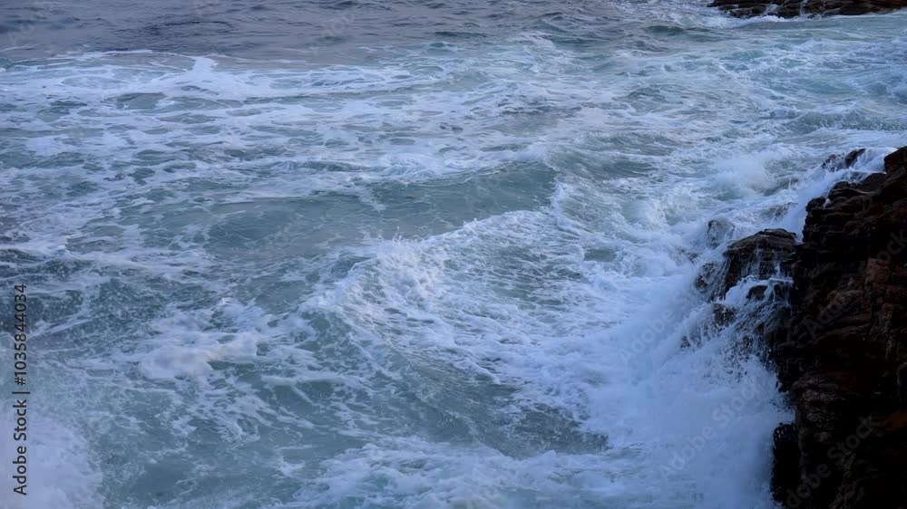 High view wave crash against rocks at sunset. Rough sea. Slow motion 4K High view wave crash against rocks at sunset. Rough sea. Slow motion 4K
