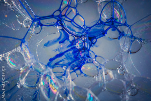 Close-up of colorful soap bubbles with iridescent reflections and vibrant blue hues.