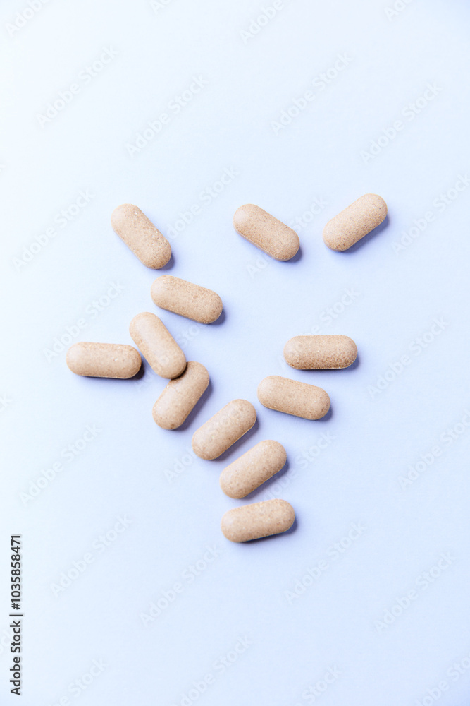 Ashwagandha (Withania somnifera) tablets on paper background. Soft focus. Close up. Copy space. Ashwagandha (Withania somnifera) tablets on paper background. Soft focus. Close up. Copy space.