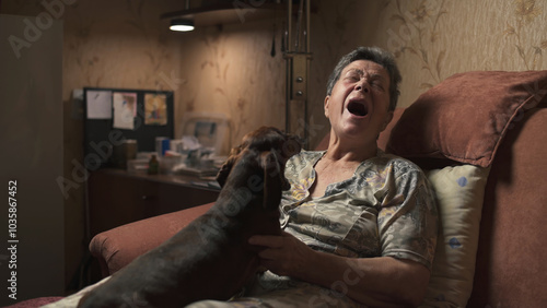 Εκτύπωση καμβά Elderly woman communicating her dachshund while sitting on sofa in modest room