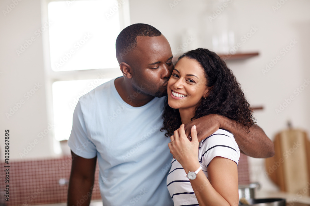 Obraz premium Kitchen, couple and happy with kiss on cheek for bonding, support and love with care. People, interracial relationship and smile on hug at home on break, rest and relax as lovers with affection