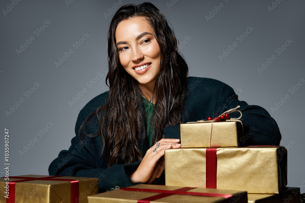 Fototapeta premium The elegant woman sits beside beautifully wrapped gifts, radiating joy and charm.