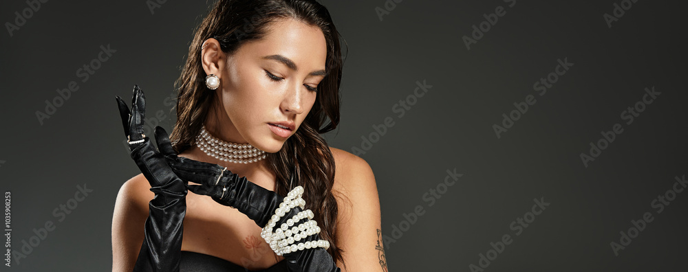 A stunning young woman gracefully poses while displaying her elegant attire and accessories.