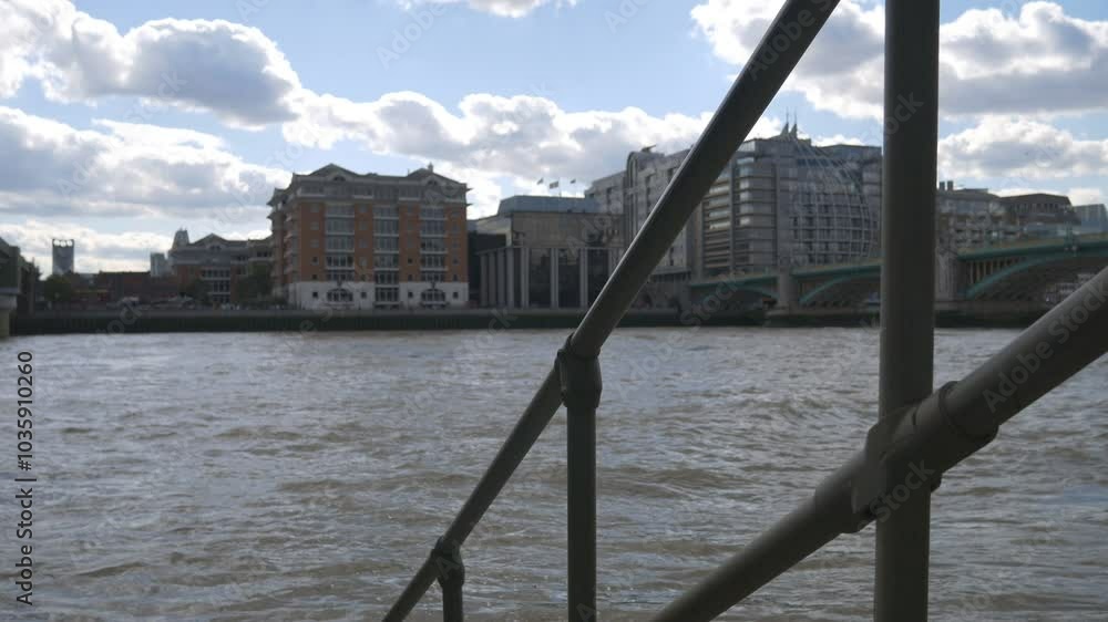Handles leading to a river with apartment buildings on the riverside.