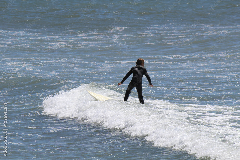 Surfer on the Malibu beach, Southern California Surfer on the Malibu beach, Southern California